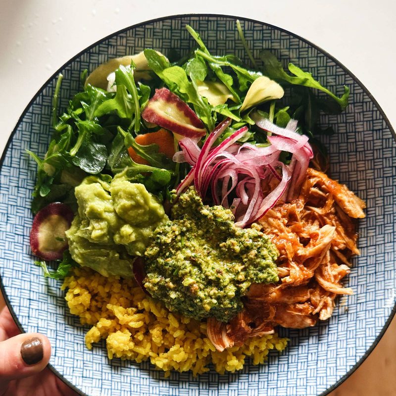 A picture of Crockpot Chicken Bowls with Yellow Rice and Cilantro Pesto
